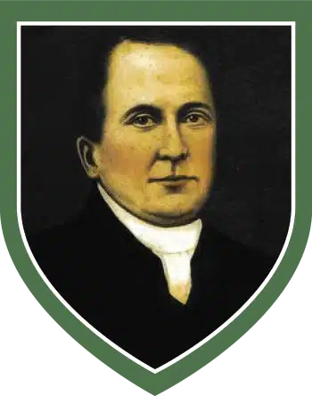 Painted portrait of a Father John Murphy, wearing dark clothing and a white clerical collar, set against a dark background and framed within a green shield border, featured at the National 1798 Rebellion Centre, Enniscorthy.