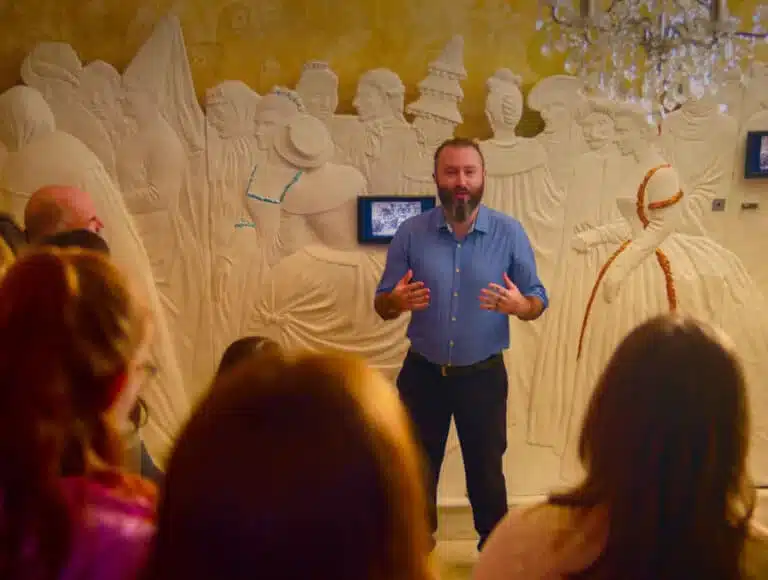 Two visitors walking across a footbridge over a pond toward the entrance of the National 1798 Rebellion Centre, Enniscorthy.