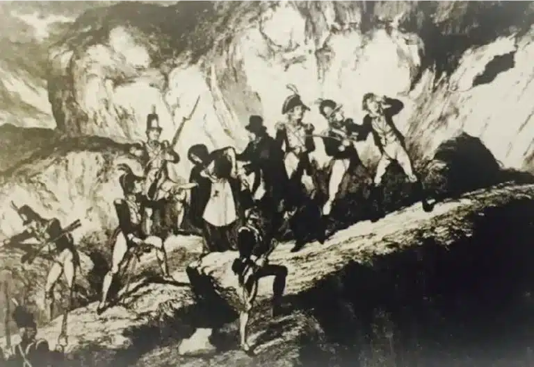 Print of soldiers and rebels clashing on rocky terrain during the 1798 Rebellion, with figures aiming muskets and others fleeing across a rugged hillside, featured at the National 1798 Rebellion Centre, Enniscorthy.