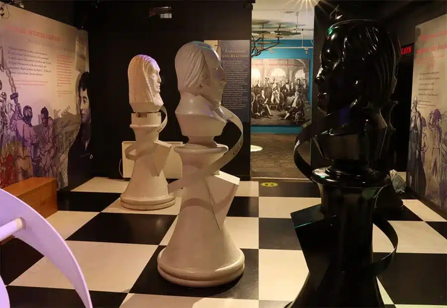 Exhibition room with large sculpted chess-piece figures representing historical characters, displayed on a black and white checked floor at the National 1798 Rebellion Centre, Enniscorthy.