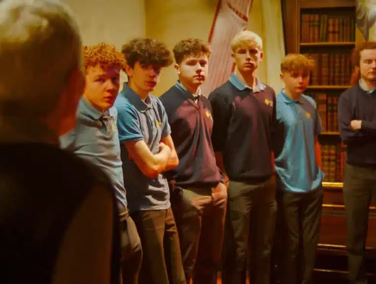 Group of teenage boys in school uniforms listening to a guide during a tour in the National 1798 Rebellion Centre, Enniscorthy.