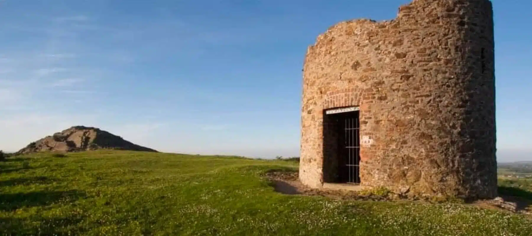 Ruin of stone watchtower on Vinegar Hill overlooking the surrounding Wexford countryside, at sunset.