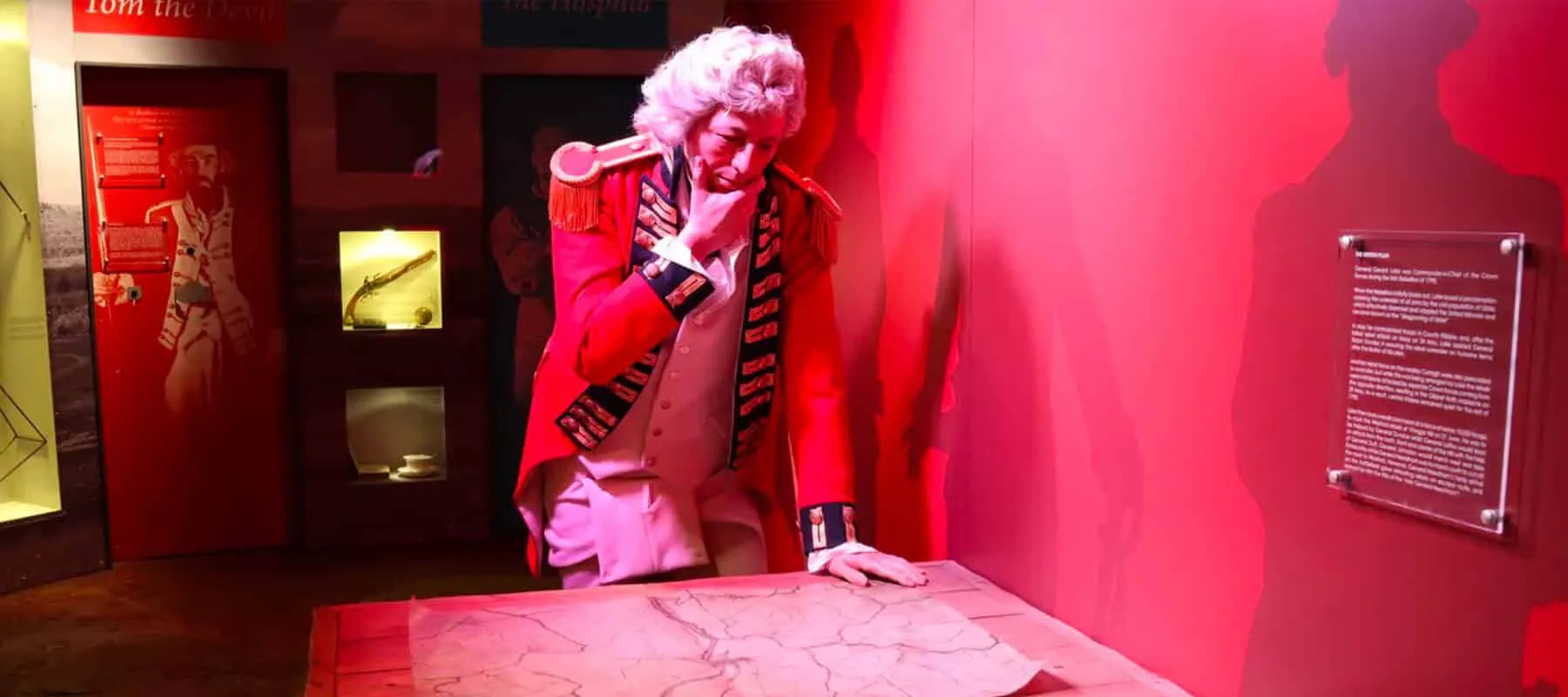 Exhibit in the National 1798 Rebellion Centre, Enniscorthy.of a mannequin of General Lake in a red uniform studying a campaign map on a wooden table.